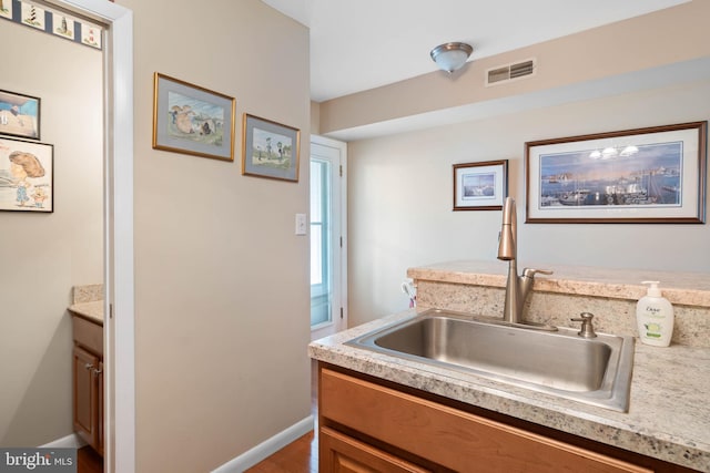 kitchen featuring hardwood / wood-style flooring and sink