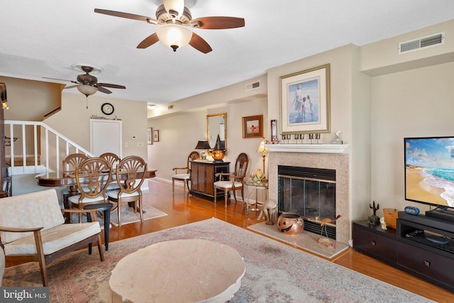 living room featuring hardwood / wood-style floors and ceiling fan