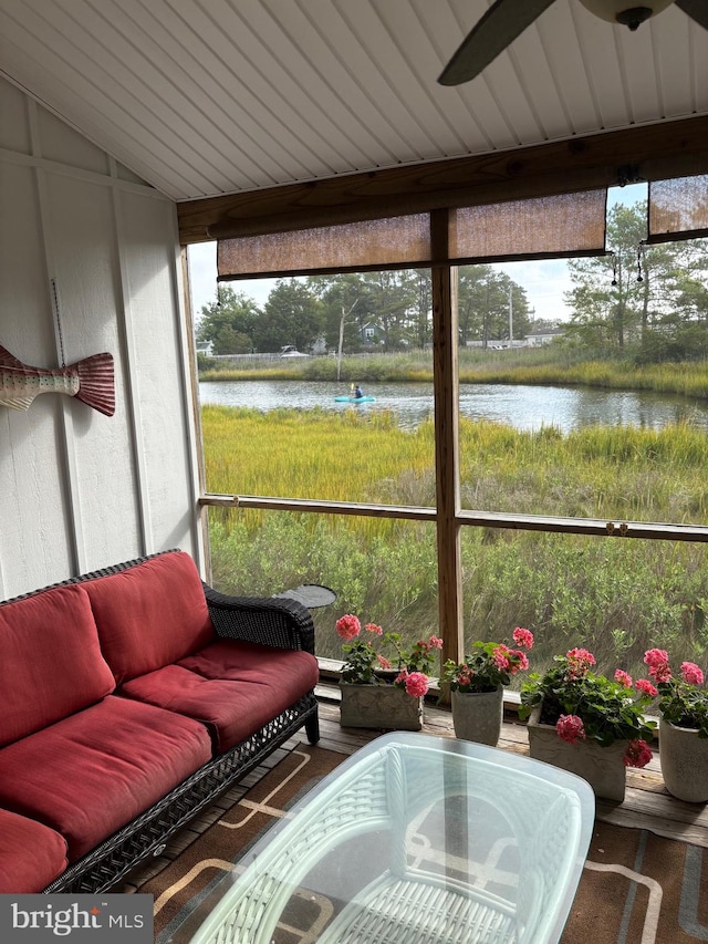 sunroom featuring a water view and a healthy amount of sunlight