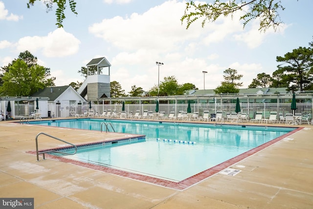 pool featuring a patio area and fence