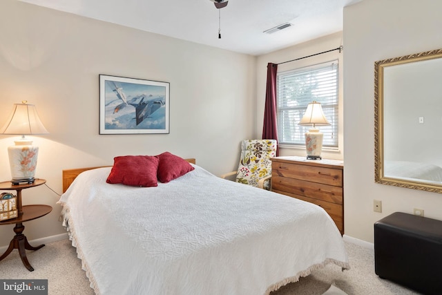 carpeted bedroom featuring visible vents and baseboards