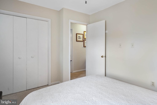 bedroom with carpet and a closet