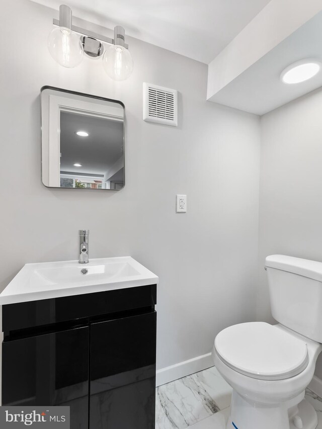 bathroom featuring a tile shower and vanity