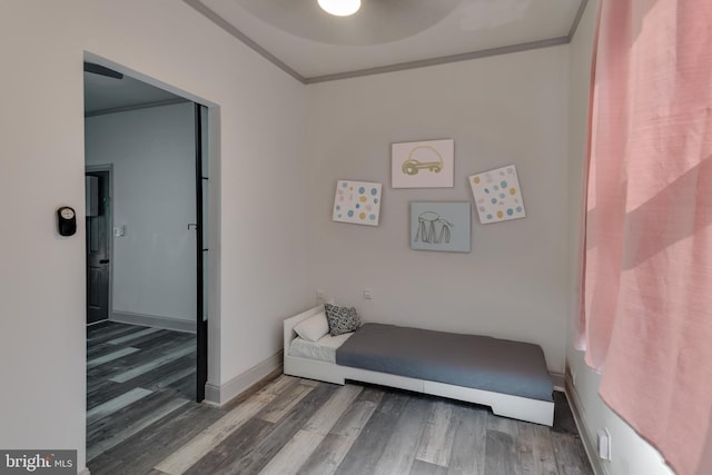 living area featuring crown molding and wood-type flooring