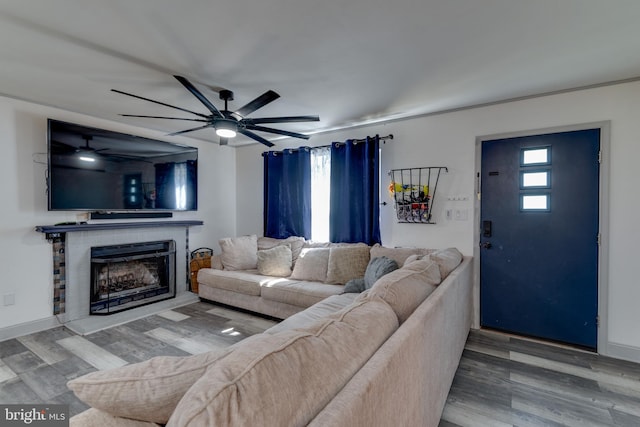 living room featuring wood-type flooring and ceiling fan