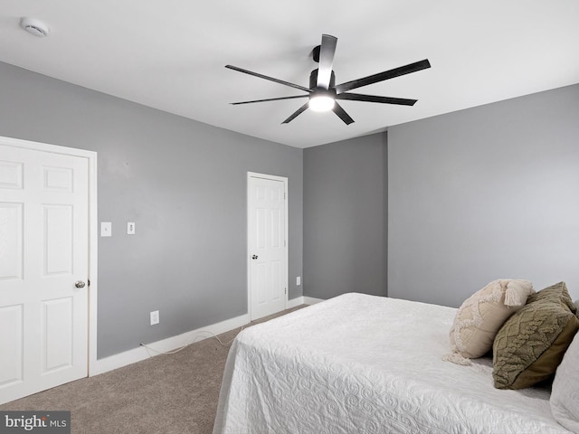 carpeted bedroom featuring a ceiling fan and baseboards