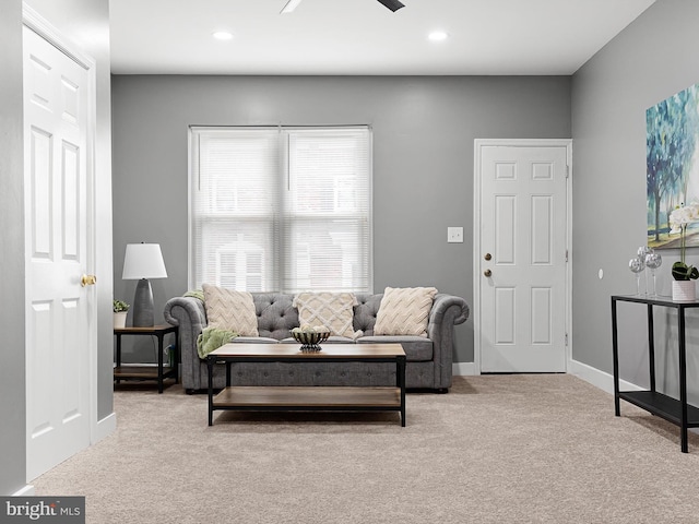 carpeted living room featuring ceiling fan