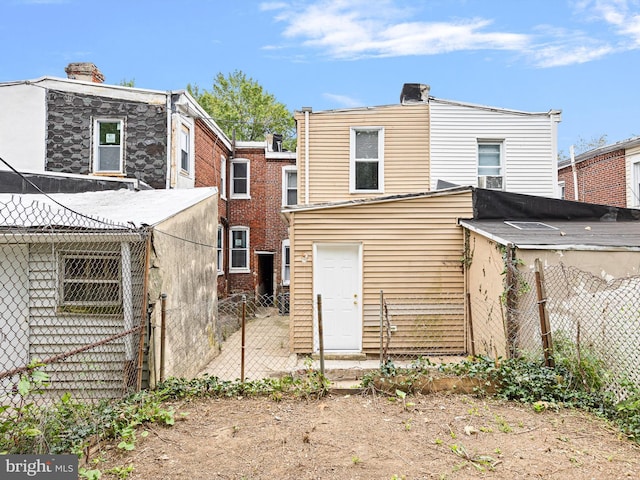 rear view of property with fence