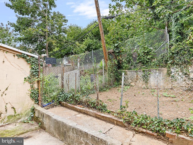 view of yard featuring a vegetable garden and fence