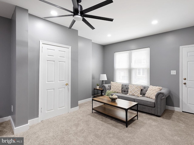 living room with light colored carpet and ceiling fan