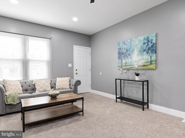 carpeted living area with recessed lighting and baseboards