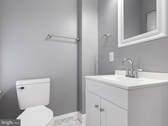 bathroom with toilet, baseboards, visible vents, and vanity