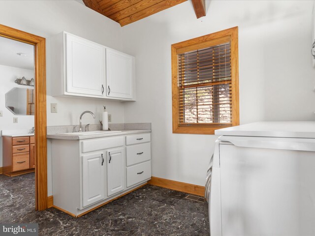 laundry room featuring washer / clothes dryer, sink, and cabinets