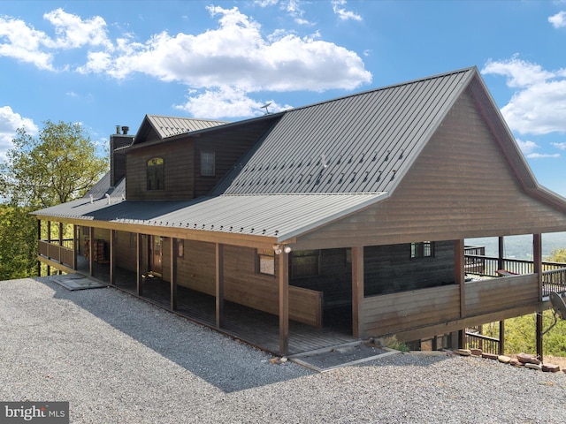 exterior space with a carport and a deck with water view