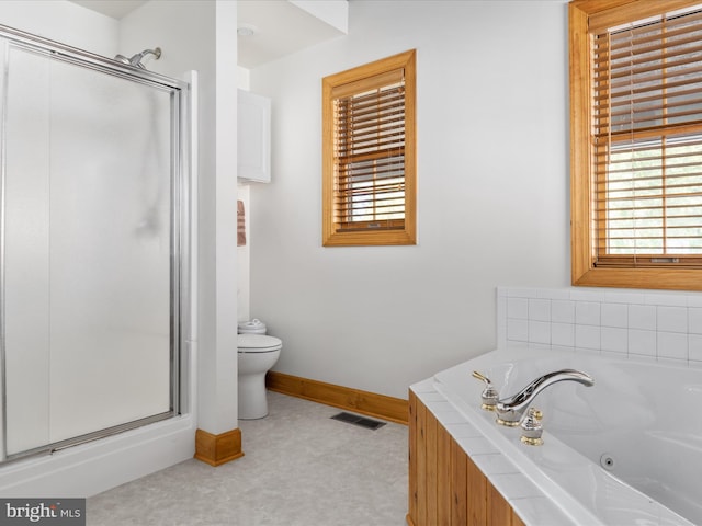 bathroom featuring plus walk in shower and toilet