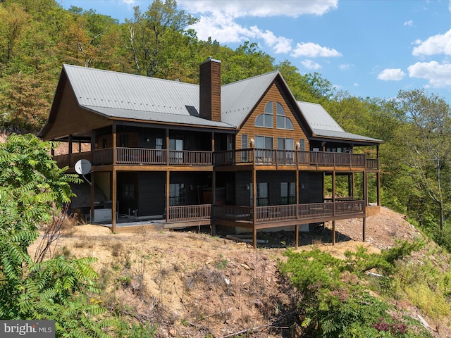 rear view of house with a balcony and a deck