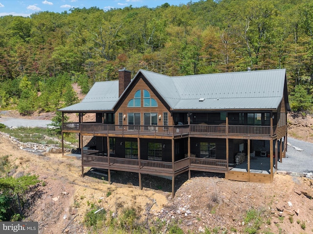 rear view of property featuring a deck