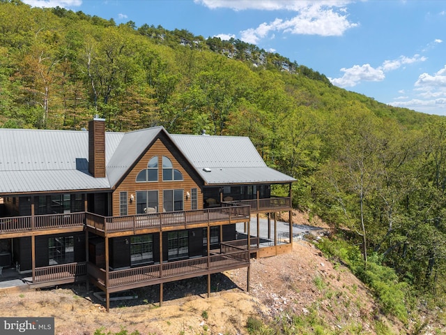 rear view of house featuring a deck