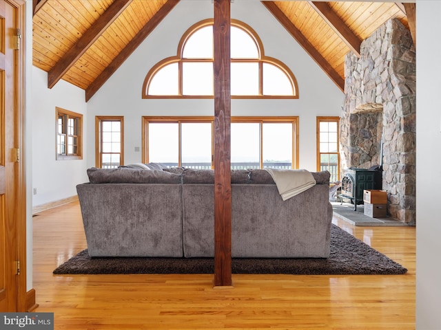 living room with a wealth of natural light, light hardwood / wood-style flooring, and high vaulted ceiling