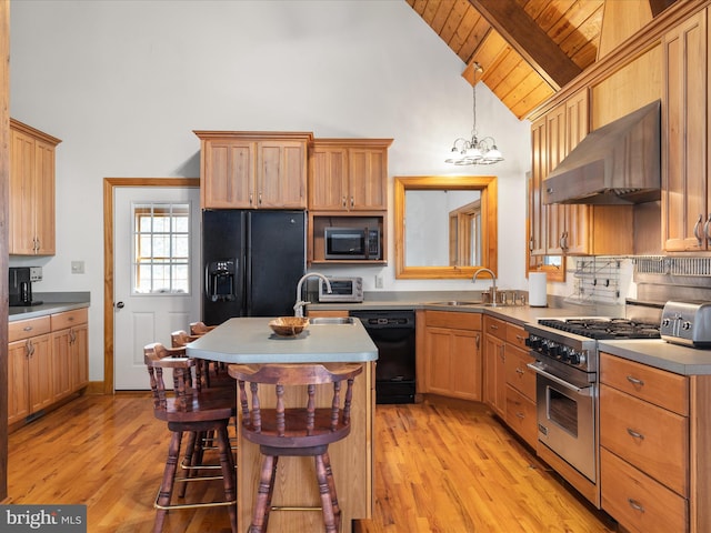 kitchen with pendant lighting, wall chimney exhaust hood, a chandelier, black appliances, and wooden ceiling