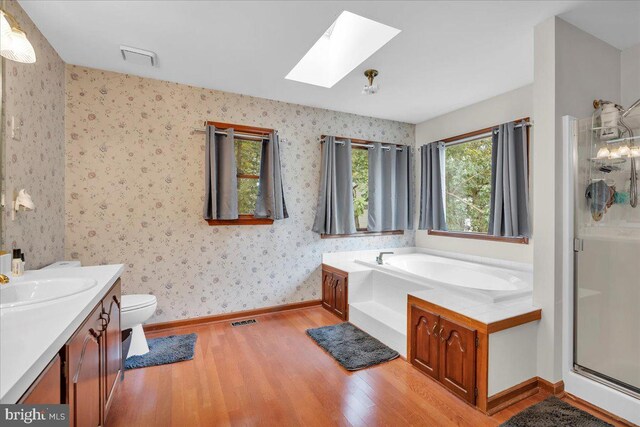 8 Annapolis Dr, Sicklerville, NJ 08081 - full bathroom featuring a skylight, visible vents, a stall shower, wood finished floors, and wallpapered walls