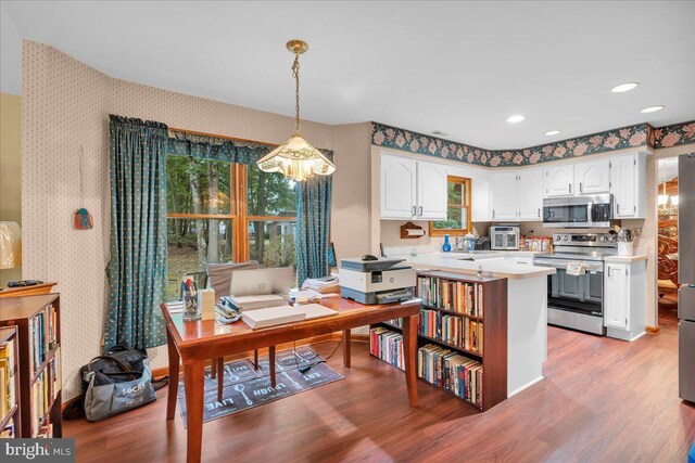 8 Annapolis Dr, Sicklerville, NJ 08081 - kitchen with wallpapered walls, white cabinets, wood finished floors, stainless steel appliances, and light countertops