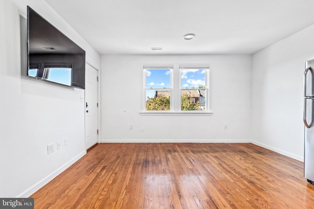 unfurnished room featuring hardwood / wood-style flooring