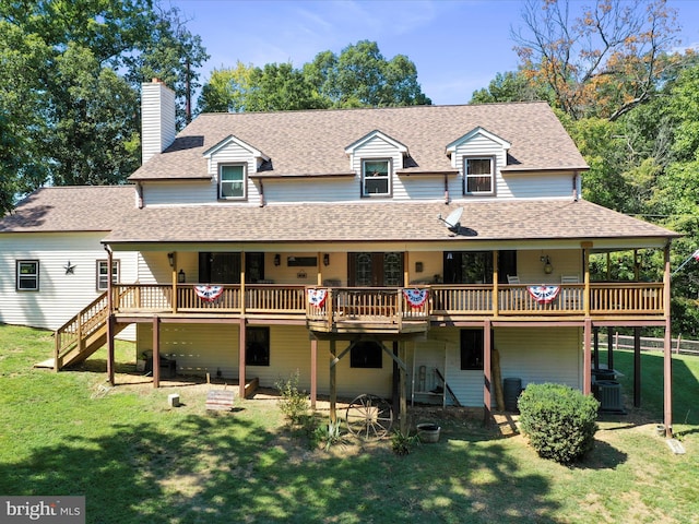 back of property with central air condition unit, a chimney, a yard, roof with shingles, and stairs