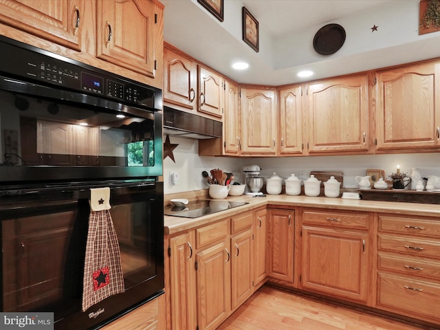 kitchen with black appliances and light wood-type flooring