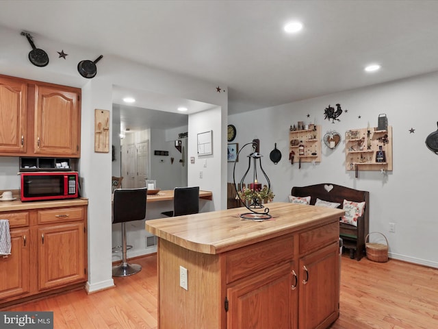 kitchen featuring a center island and light hardwood / wood-style floors