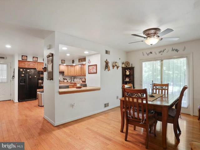 dining area featuring light wood-type flooring, sink, and ceiling fan