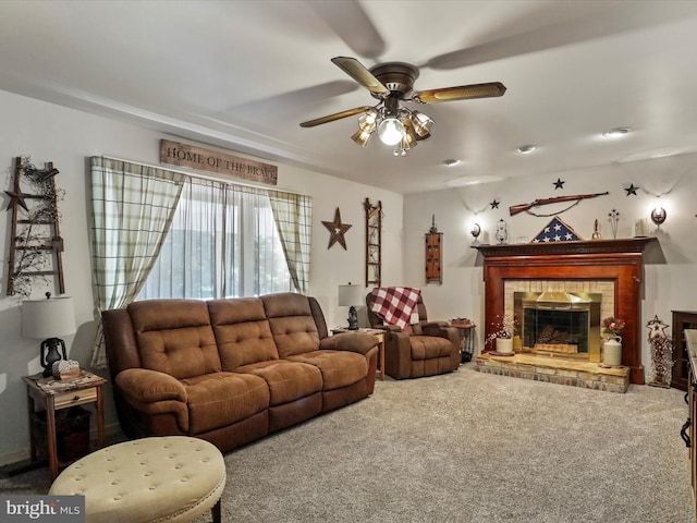 carpeted living room with ceiling fan and a brick fireplace