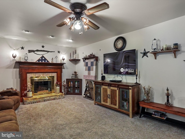 carpeted living room with ceiling fan and a brick fireplace