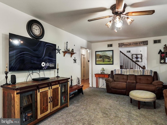 carpeted living room with ceiling fan