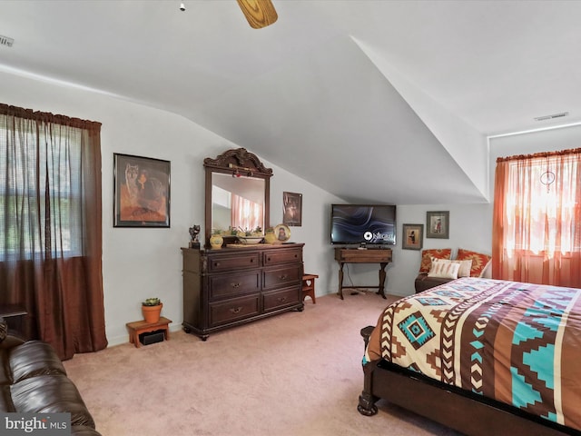 bedroom featuring light carpet and vaulted ceiling