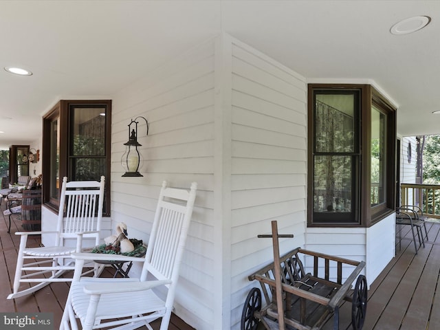 wooden terrace featuring covered porch