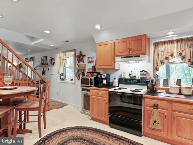 kitchen with light carpet and range with electric cooktop