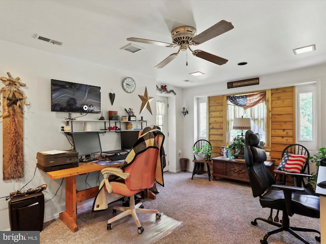 carpeted office featuring ceiling fan