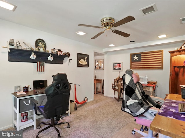 carpeted home office featuring ceiling fan