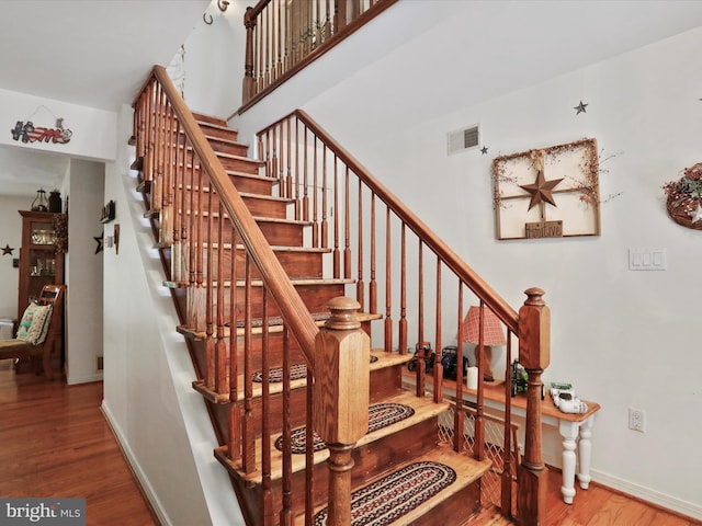 stairs featuring wood-type flooring