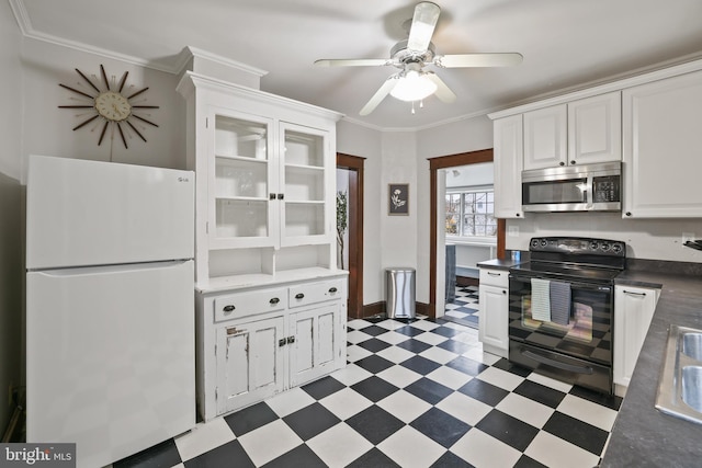 kitchen with ornamental molding, white refrigerator, white cabinets, and black electric range