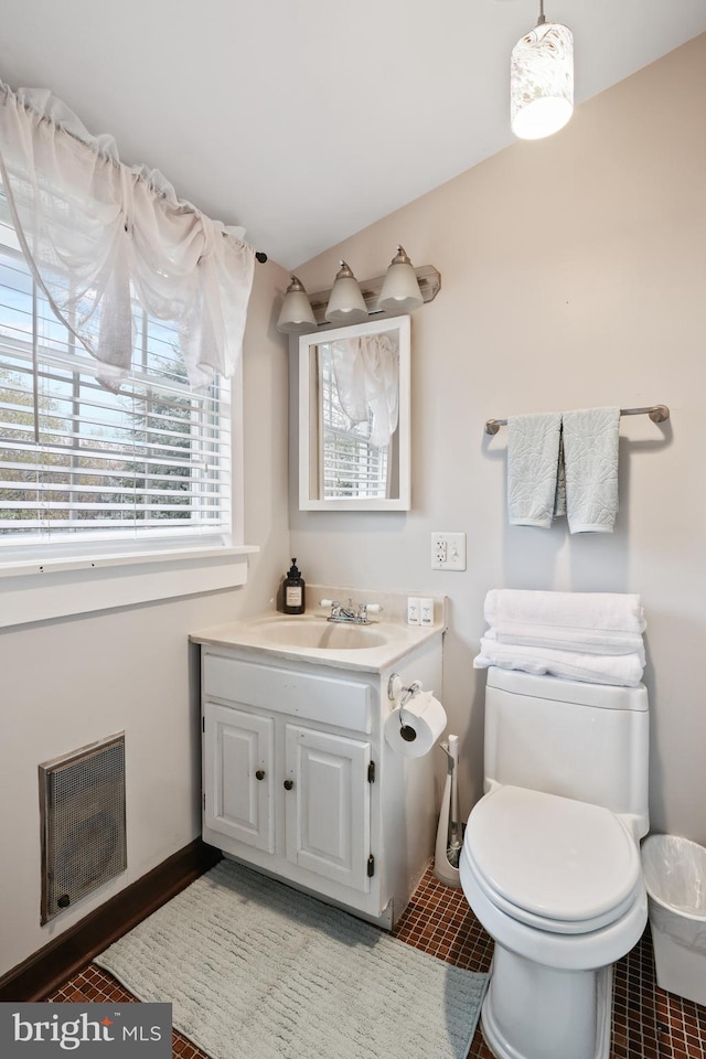 bathroom featuring tile patterned floors, vanity, and toilet