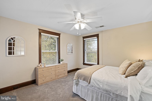 bedroom featuring ceiling fan and carpet