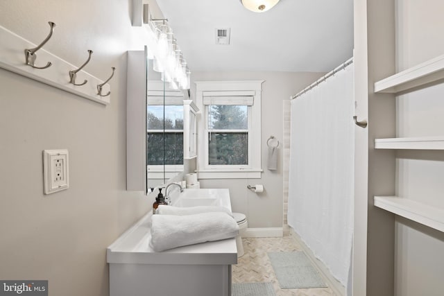 bathroom with vanity, toilet, and a shower with shower curtain