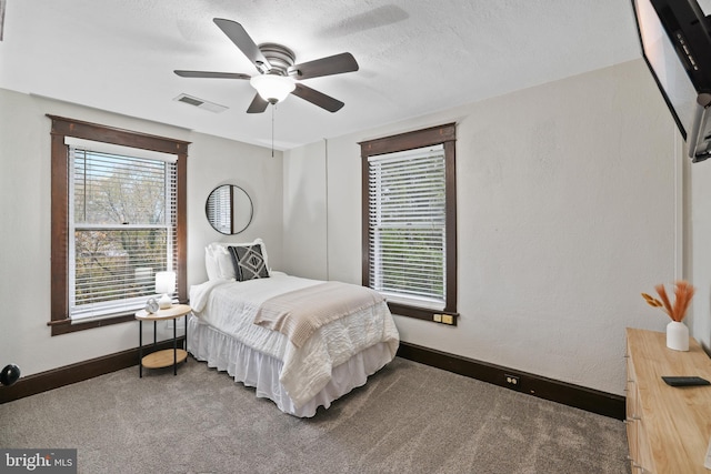 bedroom featuring carpet floors, a textured ceiling, and ceiling fan