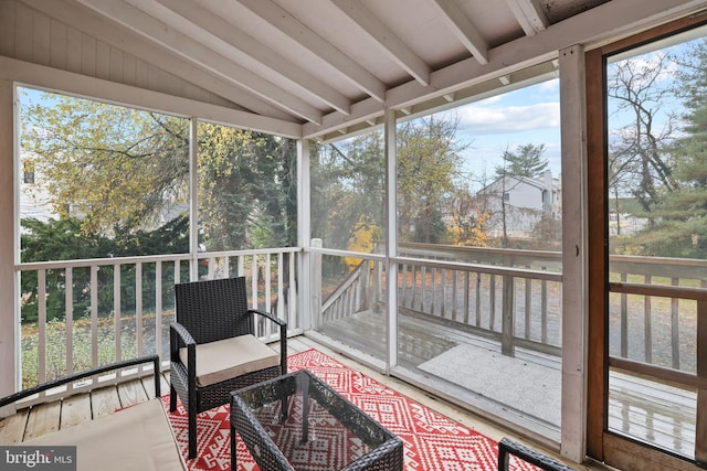 sunroom with lofted ceiling with beams