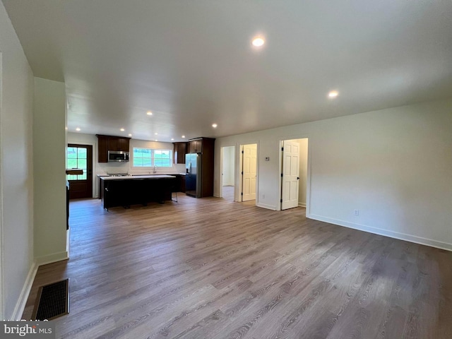 unfurnished living room with hardwood / wood-style flooring and pool table