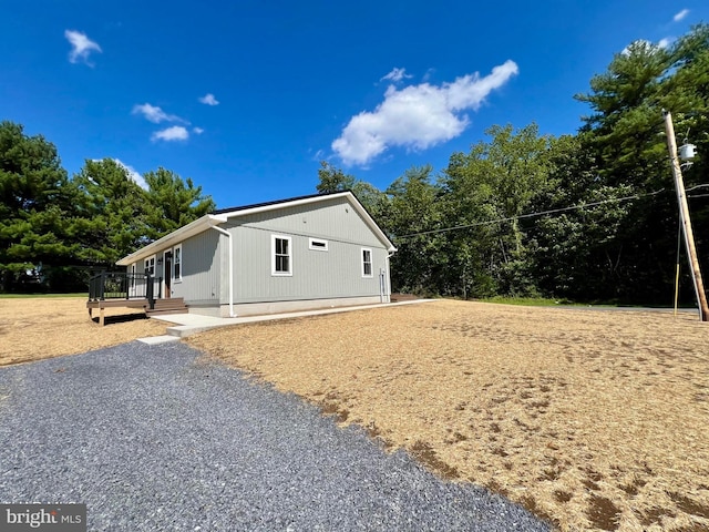 view of home's exterior featuring a wooden deck