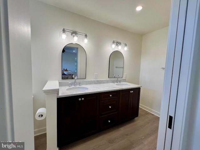 bathroom with hardwood / wood-style floors and vanity