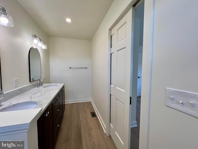 bathroom with vanity and hardwood / wood-style floors